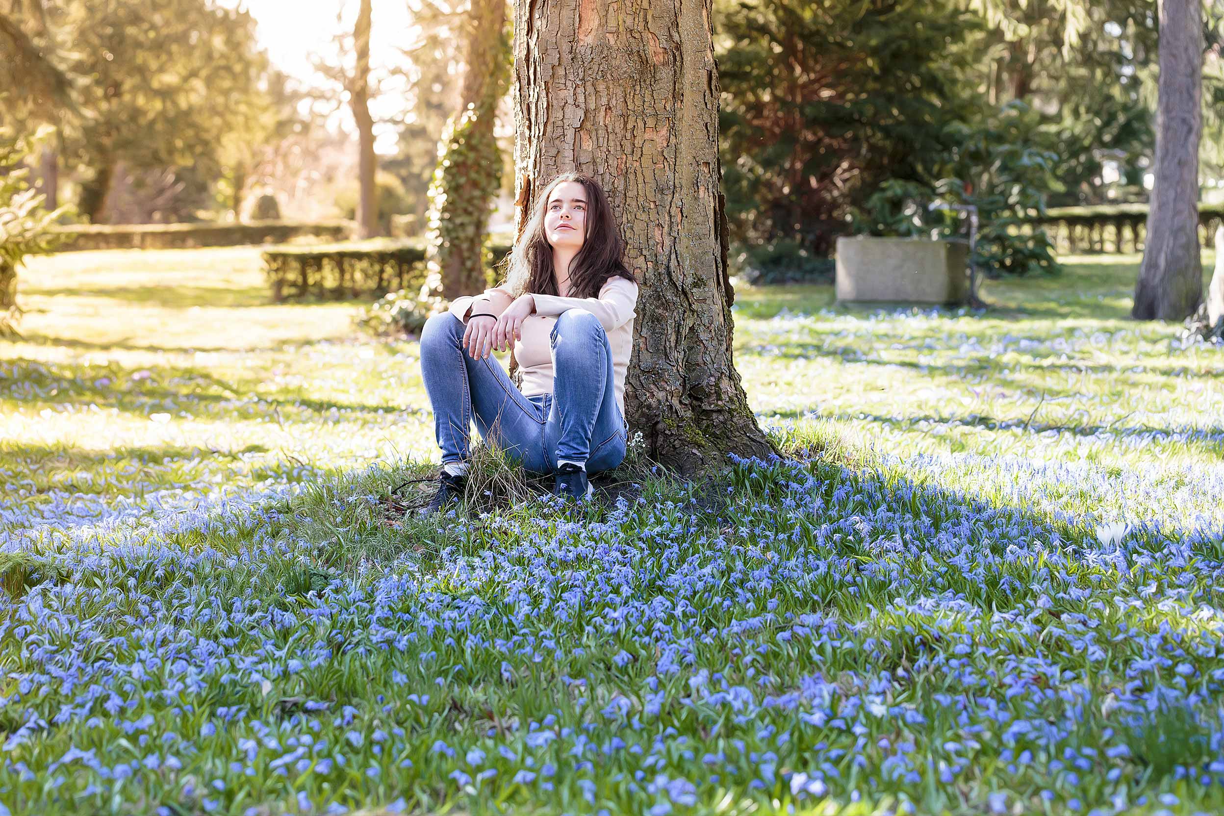 Image of girl at peace in park staring off into the distance